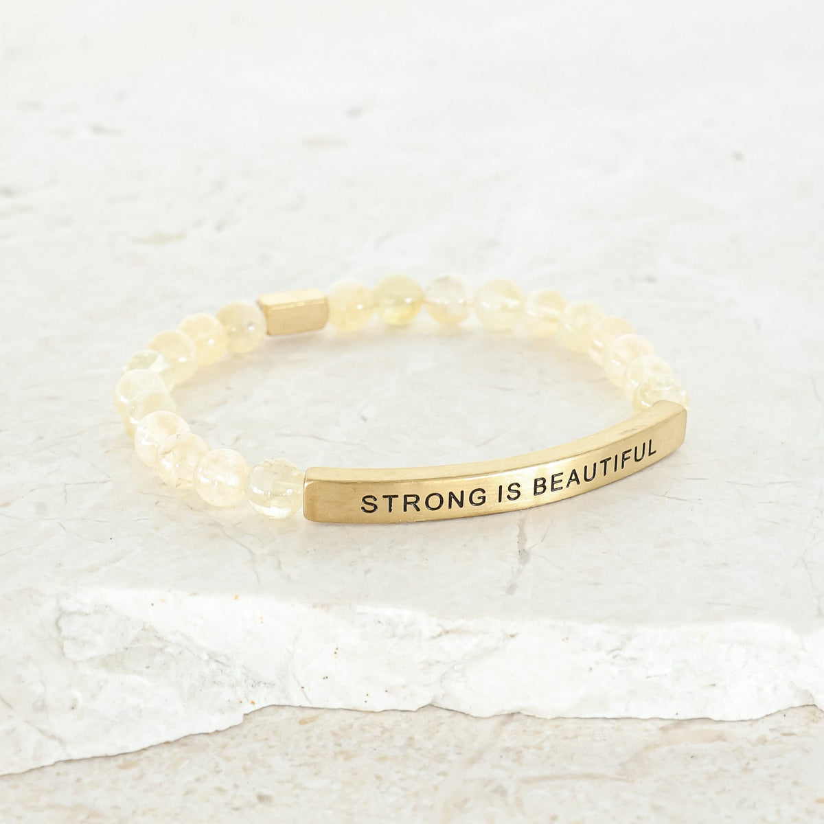 Inspirational gemstone bracelet featuring the engraved message Strong Is Beautiful