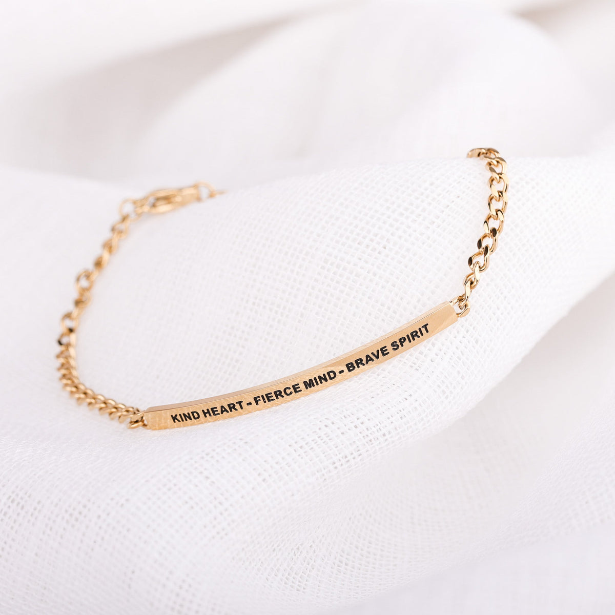 Inspirational chain jewelry bracelet celebrating kindness, strength, and courage