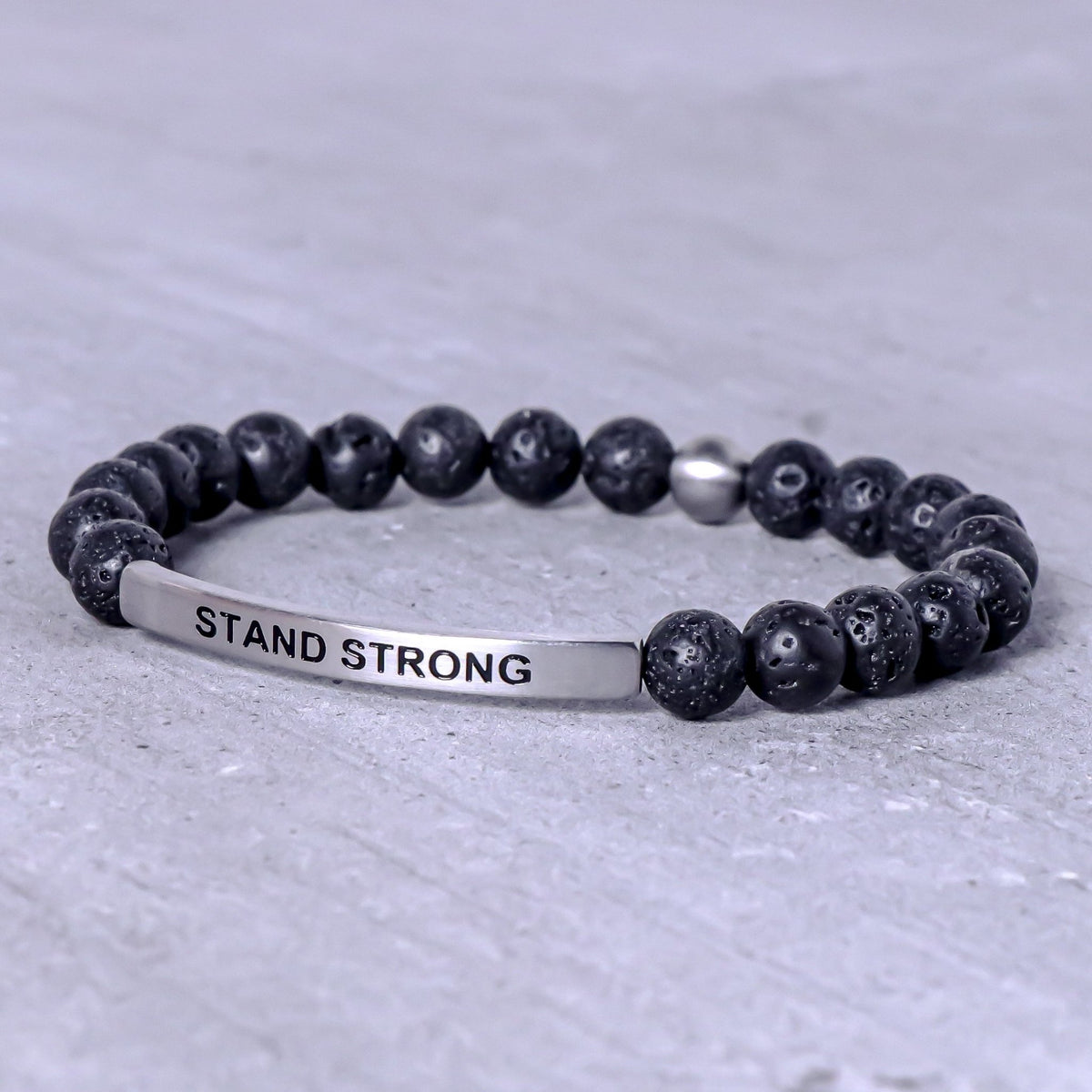 Stand Strong motivational bracelet for men featuring an engraved stainless steel message bar