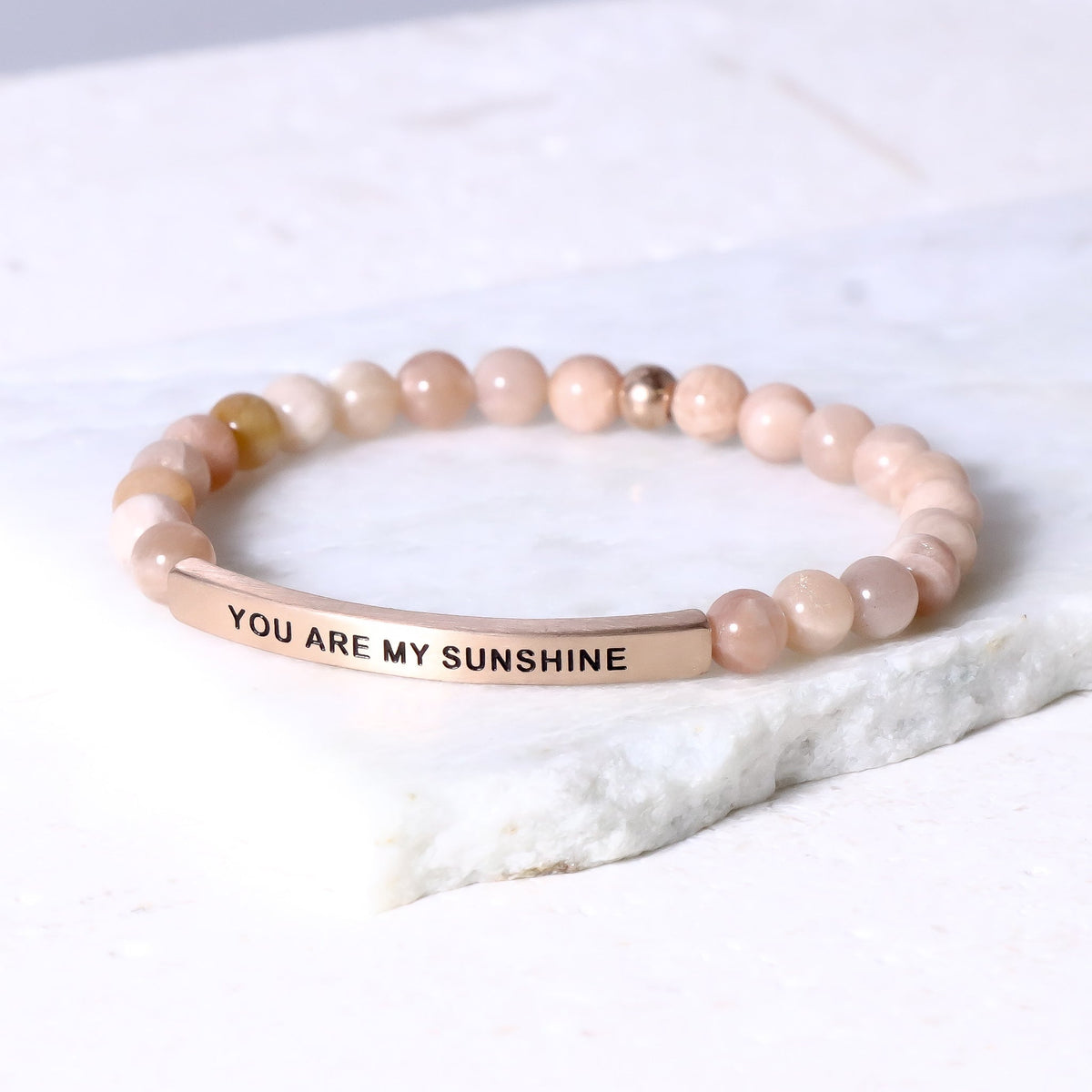 bracelet featuring an engraved inspirational message celebrating love and happiness