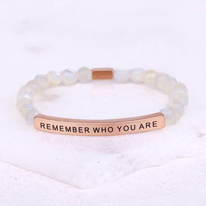 Remember Who You Are bracelet worn on wrist with gemstone beads