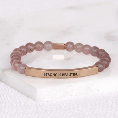 Inspirational gift bracelet for women featuring the words STRONG IS BEAUTIFUL