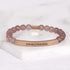 Inspirational gift bracelet for women featuring the words STRONG IS BEAUTIFUL
