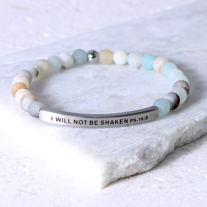 A beaded stretch bracelet with a silver-toned curved bar engraved with the text &