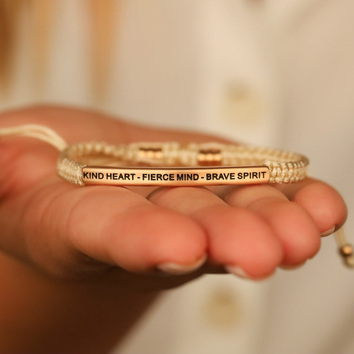 Inspirational rope bracelet celebrating kindness, confidence, strength, and courage